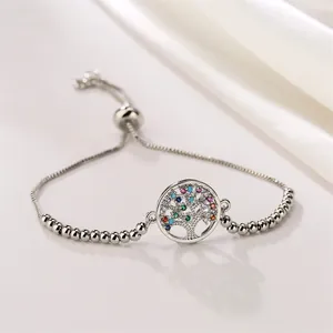 Detailed shot of silver adjustable bracelet featuring a tree of life charm with colorful stones