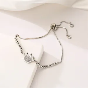 Detail of adjustable crown bracelet with cubic zirconia and slide clasp on silk