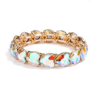 Elegant gold heart bracelet featuring AB iridescent crystal stones on white background