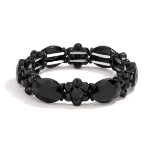 Elastic beaded bracelet featuring black faceted oval and flower beads with a glossy finish