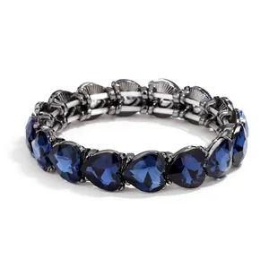 Deep blue heart-shaped gemstone bracelet with dark gunmetal grey finish on white backdrop