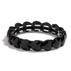 Elastic beaded heart bracelet with black faceted resin stones on a clean white background