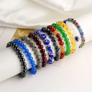 Macro detail of elastic beaded bracelets with evil eye charms and natural stone beads