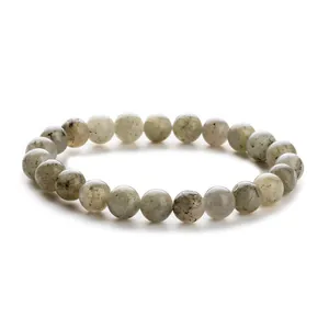 Macro detail of natural gray-white stone beaded bracelet showing unique textures and shine