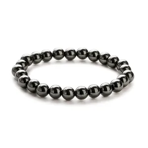Detailed view of polished black hematite beads with high metallic luster on a single bracelet