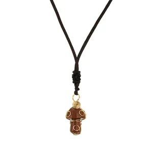Handmade mushroom necklace with gold wire wrapped goldstone pendant on brown woven cord