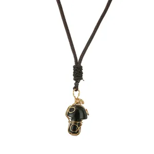 Handcrafted black obsidian mushroom pendant with gold wire wrap and brown woven cord