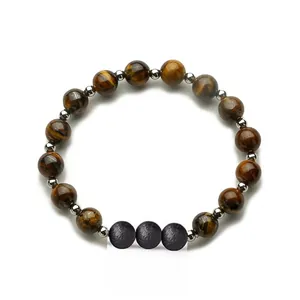 Tiger eye and volcanic stone beaded elastic bracelet with silver spacers on white background