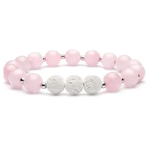 Elastic beaded bracelet with pink quartz-style beads and white volcanic lava stones