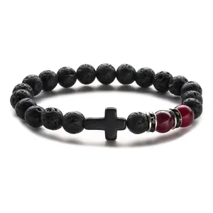 8mm black lava stone beaded bracelet with matte cross and red agate accents on white backdrop