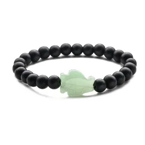 Beaded bracelet with black matte stones and a green aventurine fish charm pendant