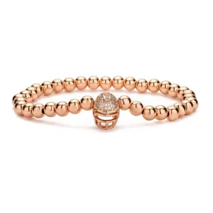 Rose gold beaded bracelet featuring a micro-paved zircon American football helmet charm