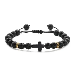 Adjustable black lava stone beaded bracelet featuring a cross charm and gold pavé accents
