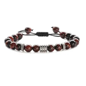 Adjustable woven bracelet featuring red tiger eye beads and silver metal accents