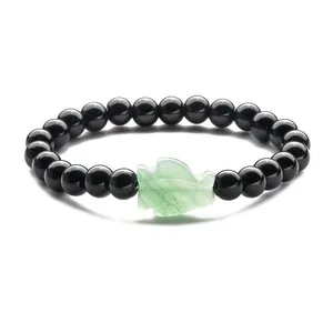 Beaded bracelet with round black onyx stones and a carved green aventurine leaf charm