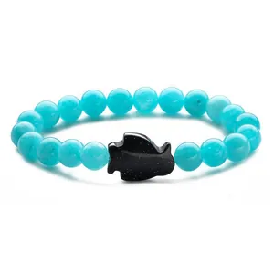 Blue translucent beaded penguin bracelet with a black glitter stone charm for men and women