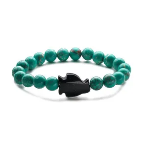 Ethnic blue stone bead bracelet featuring a black gold sandstone penguin fish charm