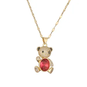Golden bear pendant necklace with micro-p镶inset zircons and a large red oval gemstone