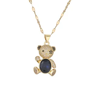 Golden teddy bear necklace with micro-paved zircons and a large navy blue oval gemstone
