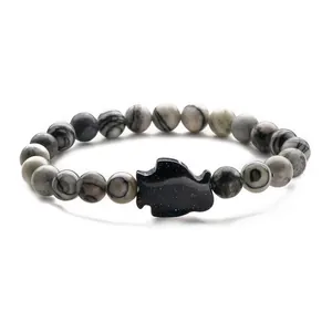 Map stone beaded bracelet featuring a dark blue goldstone map charm on white background