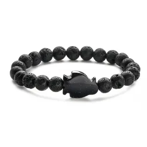 Black volcanic stone beaded bracelet with a glittering blue sandstone penguin pendant