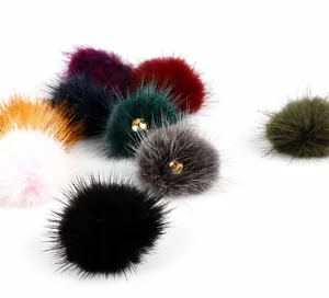 Detailed close-up of 3.5cm mink fur pompoms with metal loops for DIY jewelry making