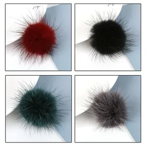 Macro detail of 3.5cm mink fur pompoms in dark red black green and grey for DIY jewelry