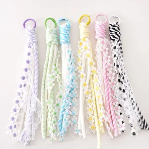 Detailed flat lay of colorful bohemian tassel charms with lace and embroidery