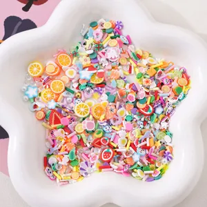 Mixed colorful fruit and flower polymer clay slices in a white star ceramic bowl