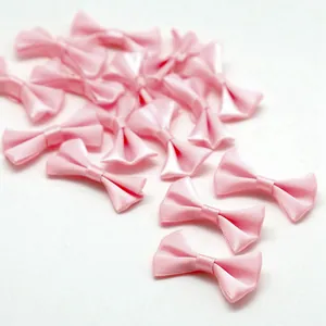 Pink satin ribbon bows for DIY hair accessories and clothing decorations on white background