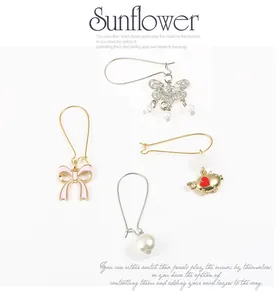 Detailed view of assorted DIY earring pendants featuring butterflies, bows, and pearls