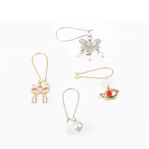 Set of four unique earring charms with pearls, butterfly and pig motifs for DIY crafting