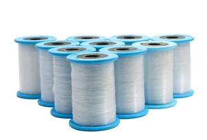 Detailed view of ten spools of clear non-elastic nylon thread for DIY jewelry making