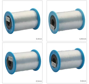 Macro detail of 0.4mm to 0.6mm clear non-stretch nylon bead strings on blue spools