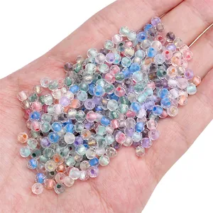 Hand holding 4mm faceted chameleon glass beads in pastel colors for DIY jewelry making
