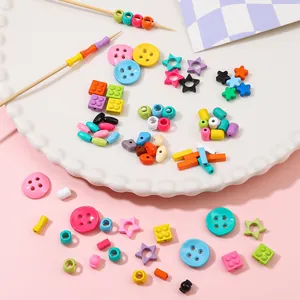 Colorful alloy star and bead charms for DIY jewelry making on a decorative white tray