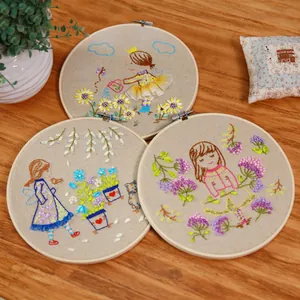 Three round bamboo embroidery hoops with colorful handmade floral illustration designs