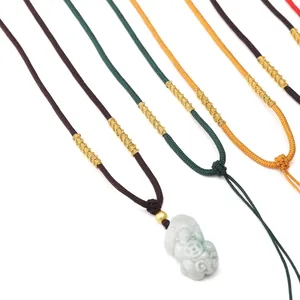 Detail of adjustable nylon braided necklace cords with dragon knots and a jade pendant