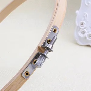 Detail of bamboo embroidery hoop with adjustable golden metal screw and knurled grip