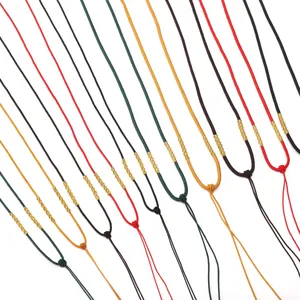 Close-up of colorful handmade braided nylon necklace cords with golden knot detail