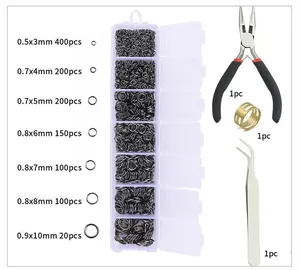 Macro view of 7-grid jewelry DIY kit with jump rings, pliers, tweezers, and ring tool