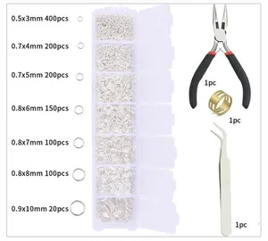 Detailed set of silver open jump rings in organizer box with jewelry pliers and tools