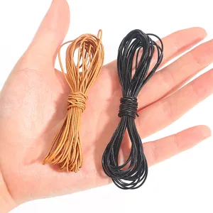 Detailed view of black and brown faux leather cords for DIY jewelry weaving and crafting