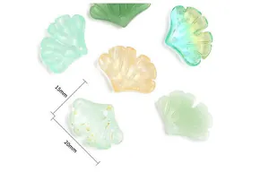 Macro detail of 20mm ginkgo leaf pendants in translucent resin with gold foil flakes