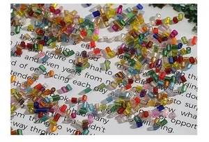 Macro shot of 2mm silver-lined glass bugle beads in mixed colors for DIY jewelry making