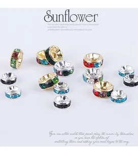 Detail of colorful rhinestone wavy spacer beads with gold and silver plated metal bases