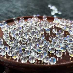 Macro view of iridescent crystal glass beads in a wooden tray for jewelry DIY