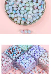 Detailed macro view of pastel colored glass beads stored in a transparent organizer box