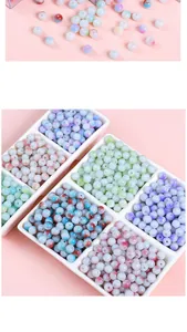 Detailed view of colorful marble texture glass beads in a white organizer tray