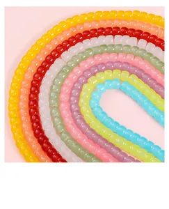 Close-up of vibrant 8x6mm barrel glass beads in a rainbow of colors for DIY jewelry